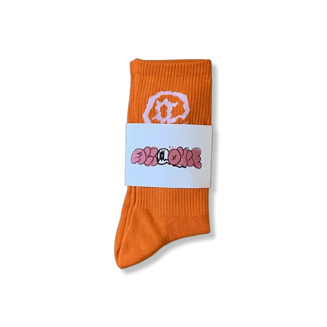 Bright orange crew sock with white graphic and branded band, stylish streetwear accessory