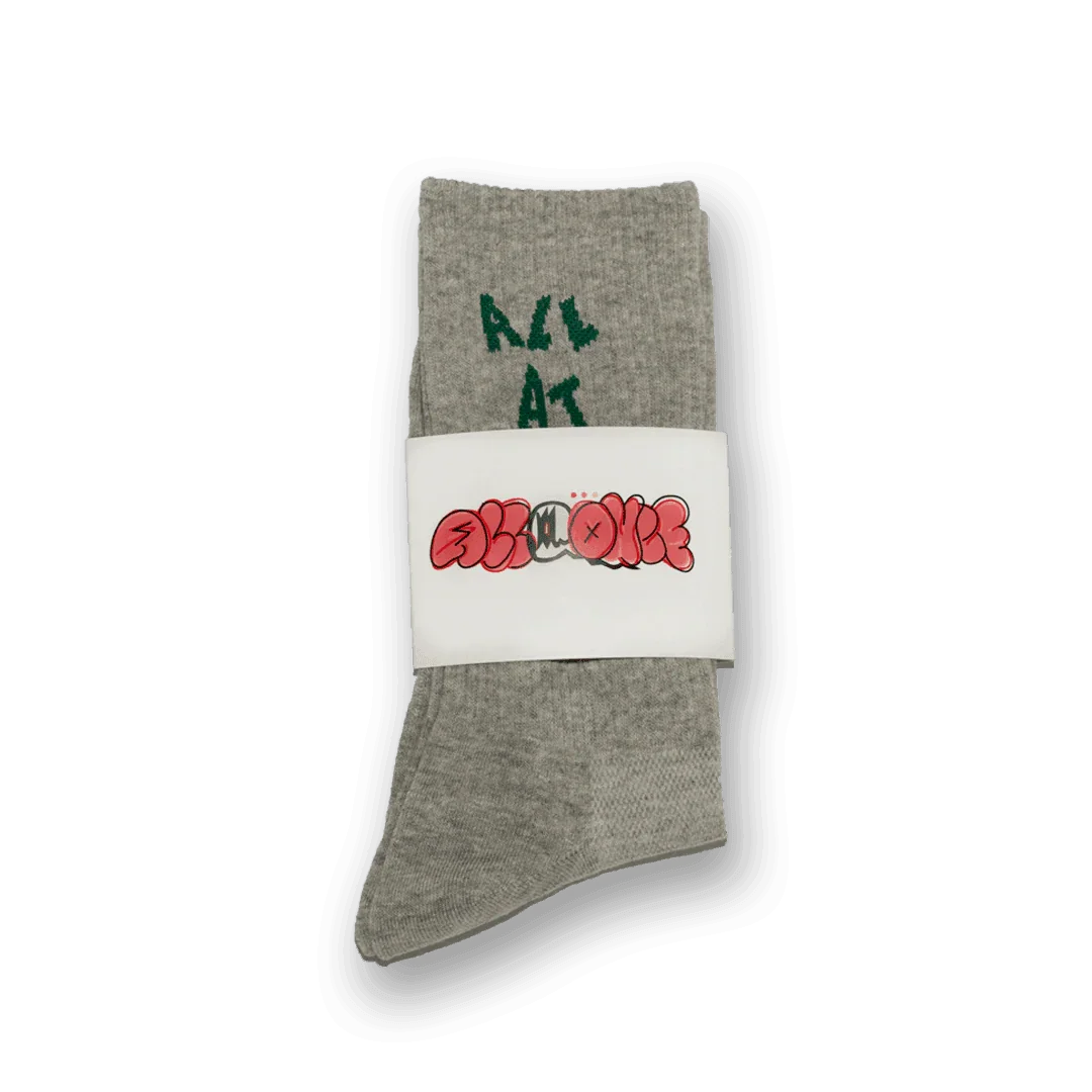 Gray crew sock with green text 'ALL AT' and unique graphic packaging, cozy casual wear