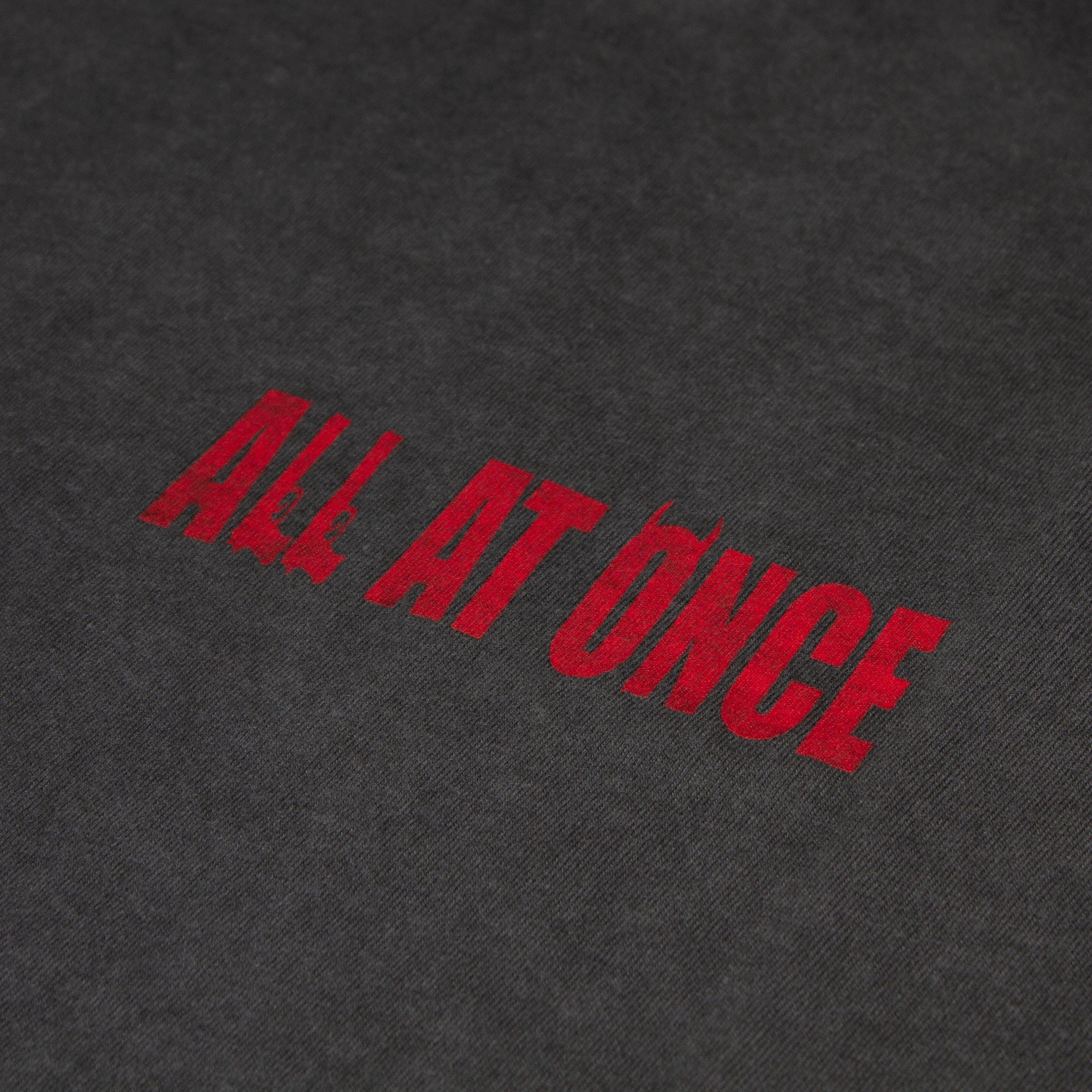 Black t-shirt with bold red ALL AT ONCE text graphic on chest
