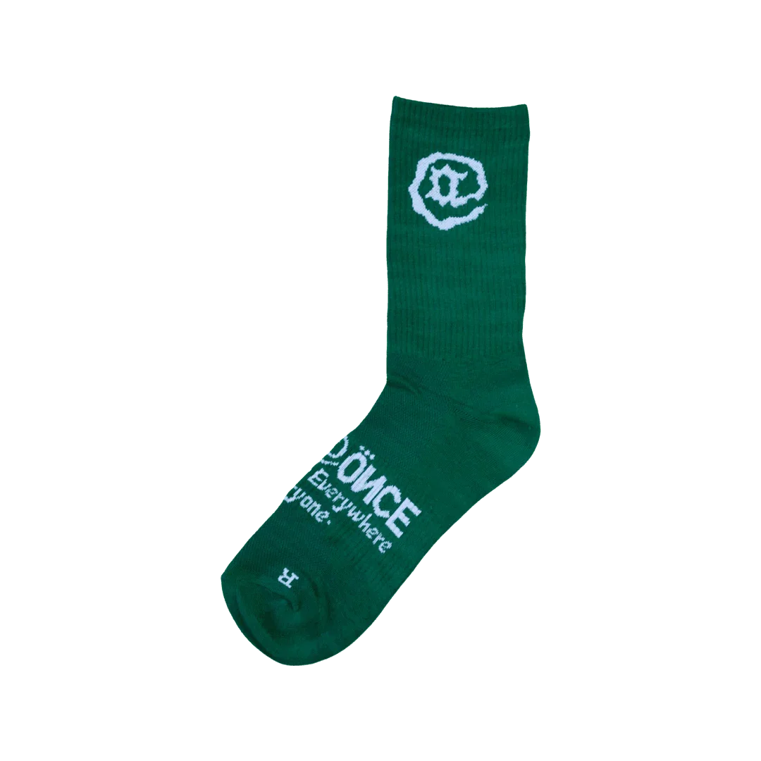 Green crew sock with white abstract logo and text design on foot and calf