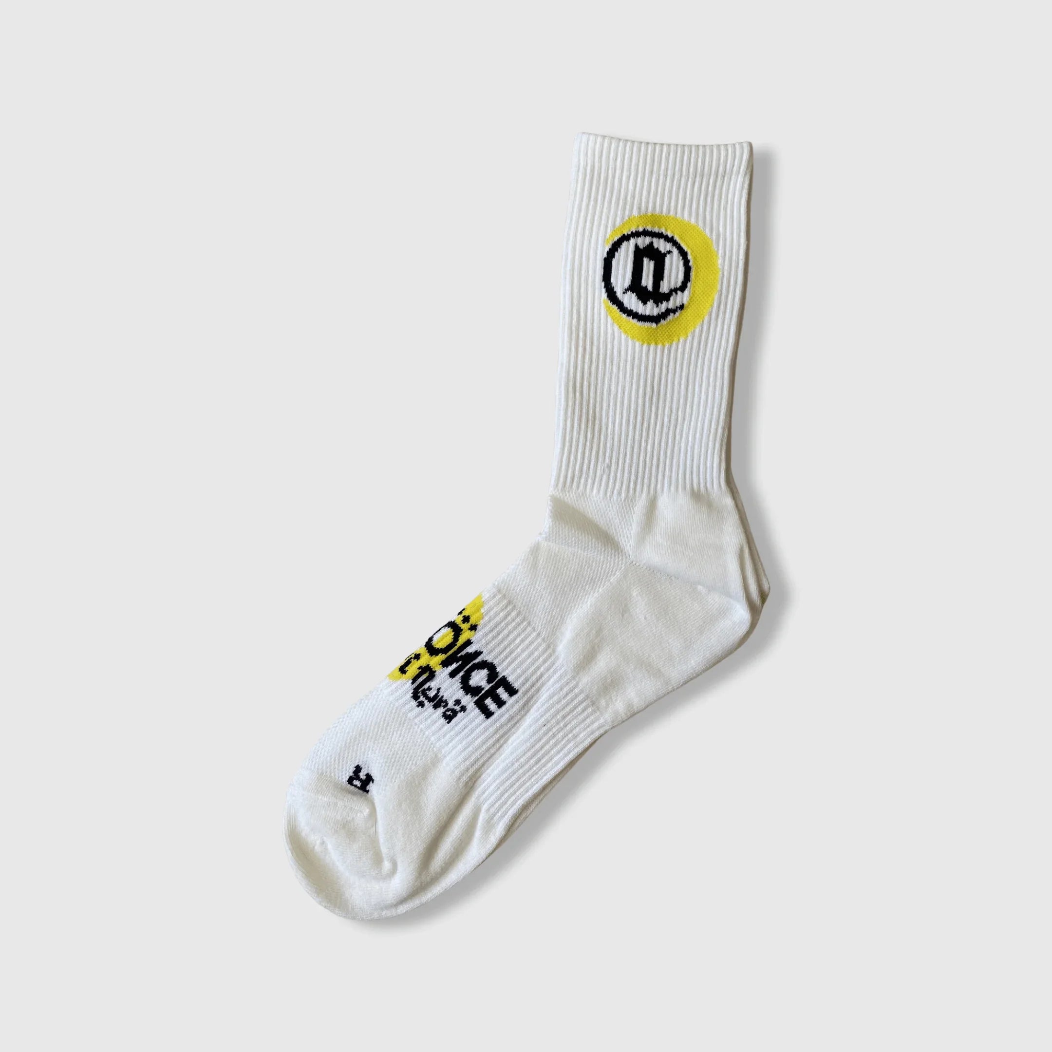 White crew sock with black and yellow graphic design and text on ankle and foot.