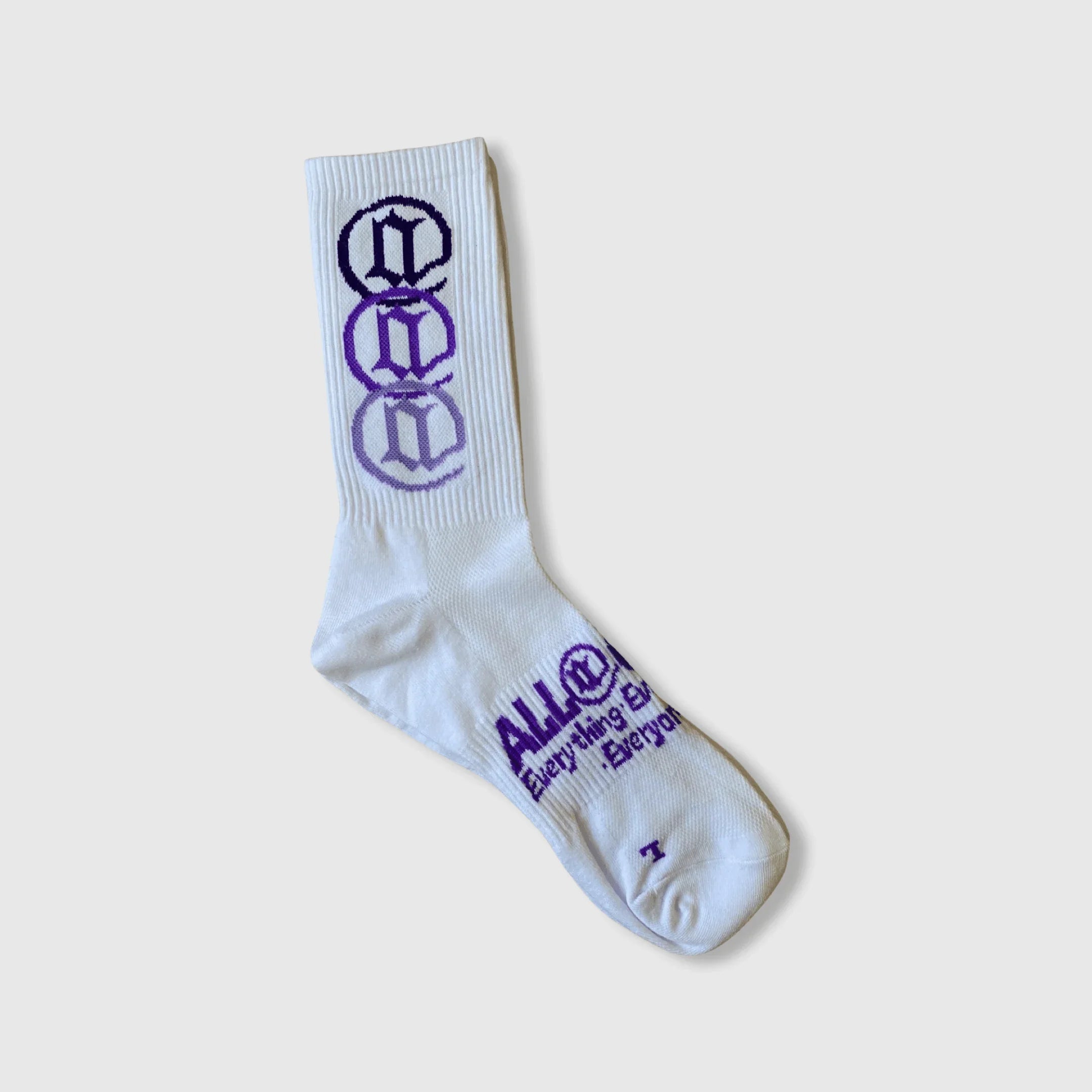 White crew sock with purple graphic design and text, modern streetwear style